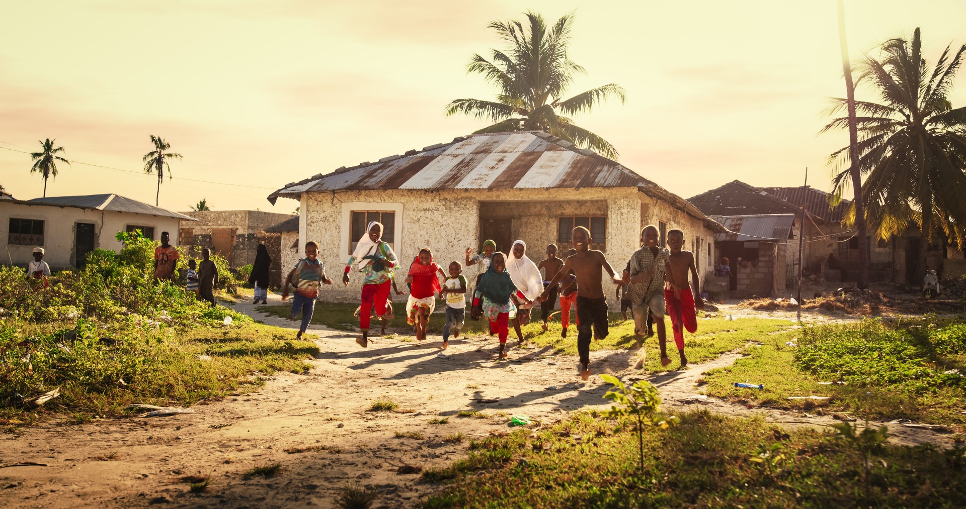 Group of African Little Children Running Towards the Camera and Laughing in Rural Village. Black Kids Full of Life and Joy Enjoying their Childhood and Playing Together. Little Faces with Big Smiles